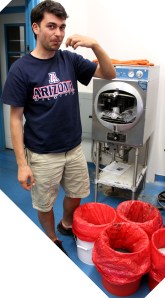 Dragos Zaharescu, Ph.D. tastes ground rock used in his plant medium. Photograph by Susan E. Swanberg.