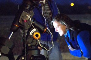 Darlene Sims examines Curt Hughes' telescope on Jan. 3, 2014 in the parking lot of Starizona in Tucson, Ariz. Sims and her family recently bought a telescope that they're eager to learn how to use. Photograph by Susan E. Swanberg
