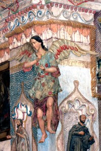 A colorful painted angel decorates the wall at San Xavier del Bac. The mission  is a living, breathing church where the Mass is celebrated every day. Photograph by Susan E. Swanberg