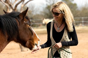 Karen Pomroy, of Equine Voices, greets Blaze. Blaze is a "wild" Sahuarita horse who now lives at Jumpin' Jack Ranch. Photograph by Susan E. Swanberg