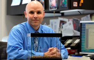 Keith Boesen, PharmD, Director of the Arizona Poison and Drug Information Center sits at his desk with a terrarium of Arizona bark scorpions on April 15, 2014. Boesen manages the day-to-day operations of the poison center. Photograph by Susan E. Swanberg.